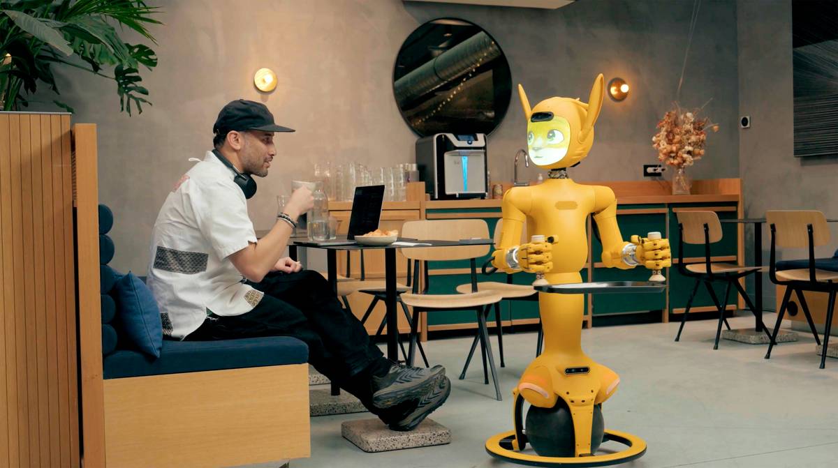 computer programming applications in robotics illustrated with a student coding a robot arm on a laptop connected to sensors and motors